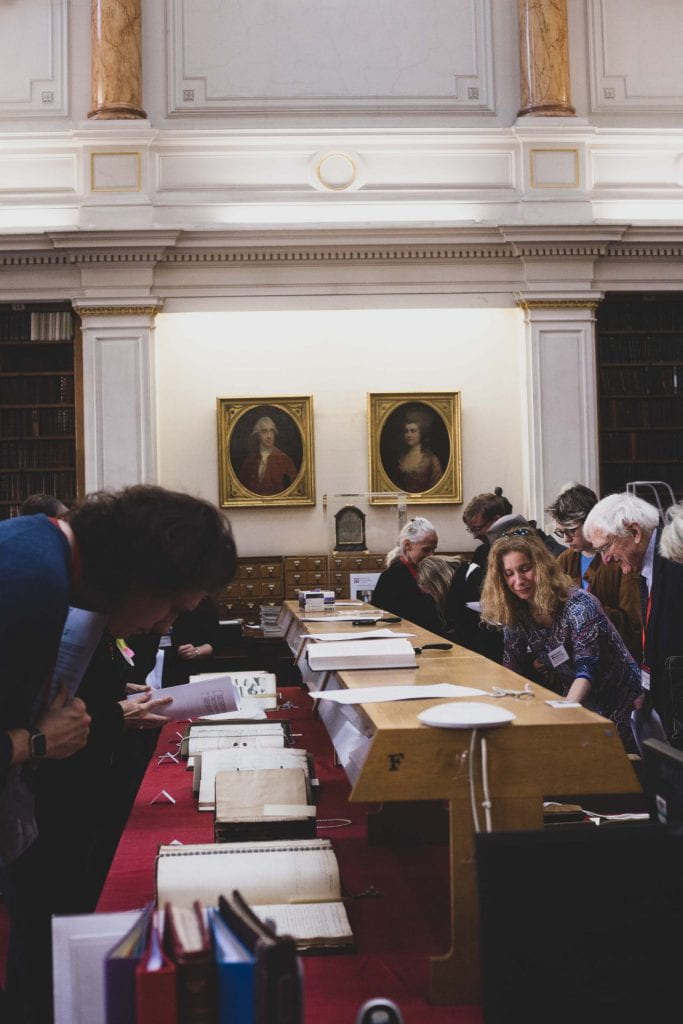 Figure 4. Conference delegates studying documents on display in the Society's library © Chelsea Brown.